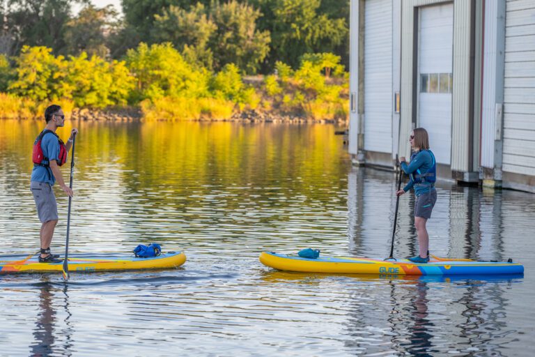 Paddlers launching from shore during a SUP session focused on building strong technique and correcting common mistakes.